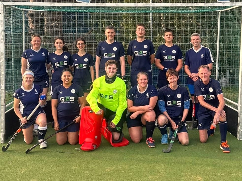 Bexleyheath & Belvedere summer league hockey team photo. Two rows looking smart in their navy blue kit, nearly all smiling!